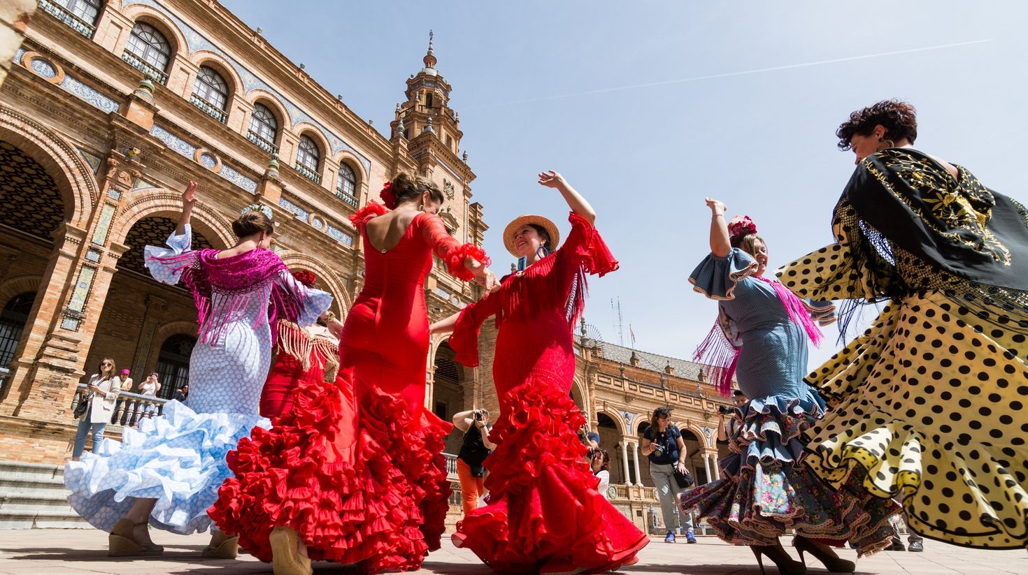 Young women dance flamenco on Plaza de Espana during famous Feria festival