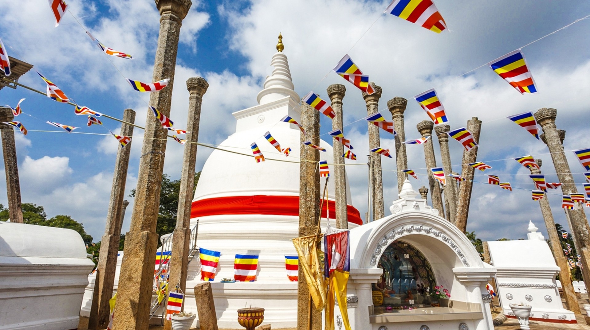 Visit Anuradhapura, a Unesco World Heritage site, to celebrate the Buddhist festival of Pason Poya. Buddhist prayer flags in Thuparama dagoba in Anuradhapura as seen in Sri Lanka during June