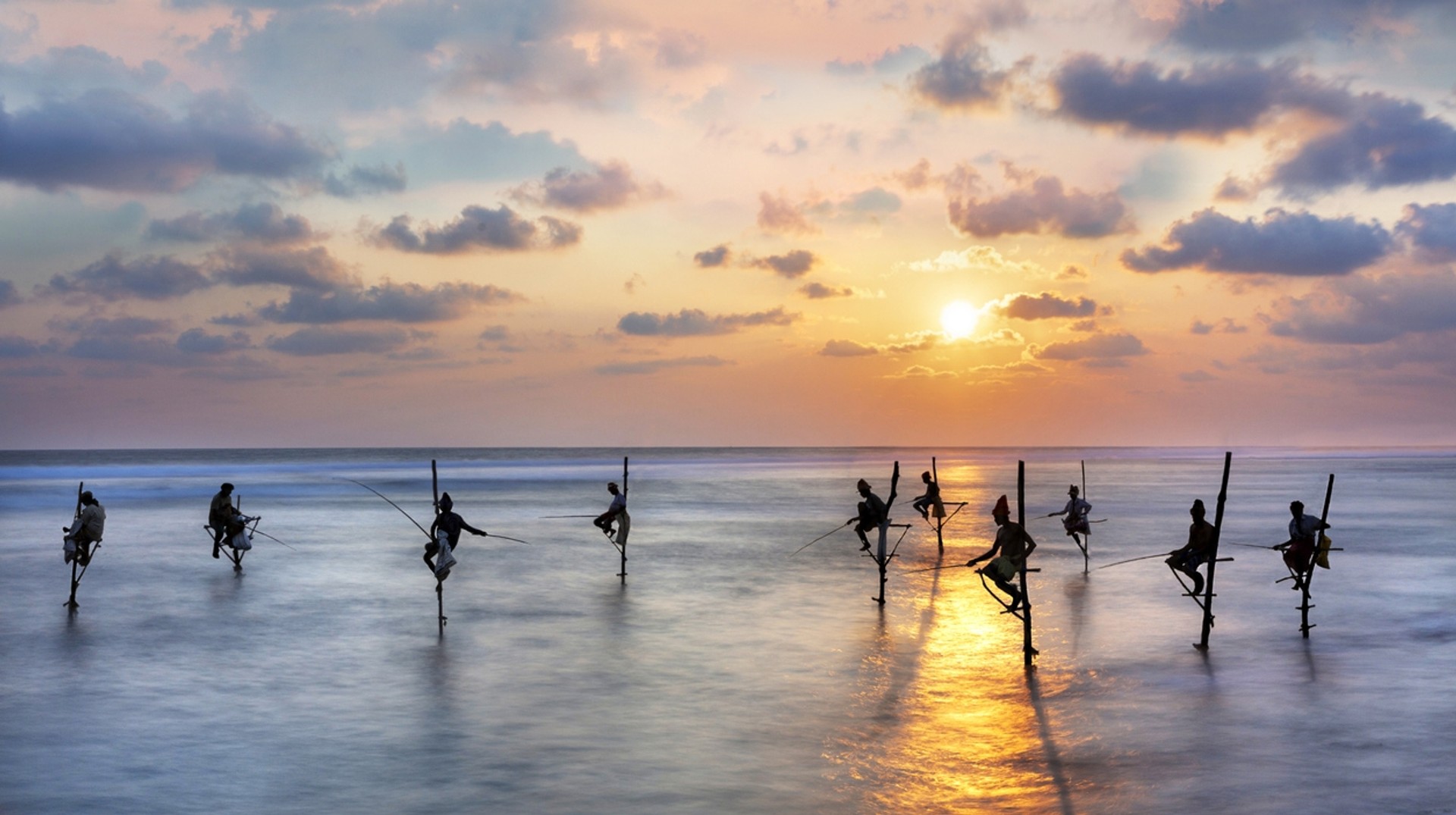 Every region of Sri Lanka boasts varying cultures and lifestyles distinct from another. Fishermen on stilts at the sunset in Galle, Sri Lanka in October
