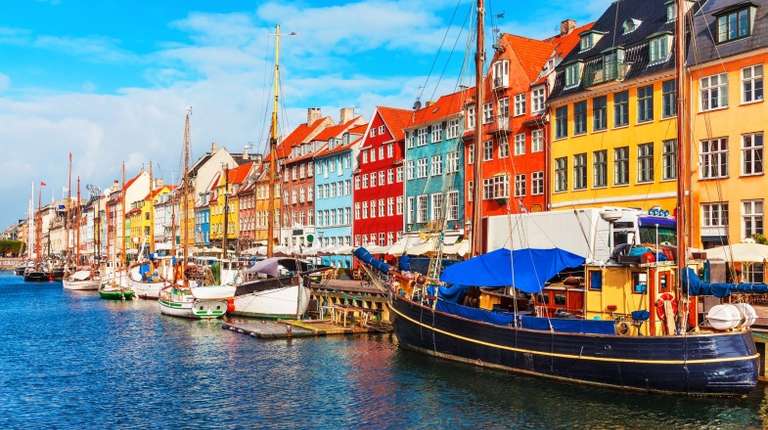 Boats and yachts lined up on the shore during summer in Denmark.