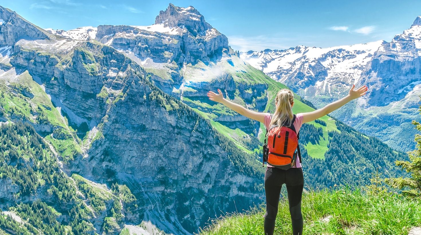 Stretch your arms and enjoy hiking to mountain tops in Switzerland.