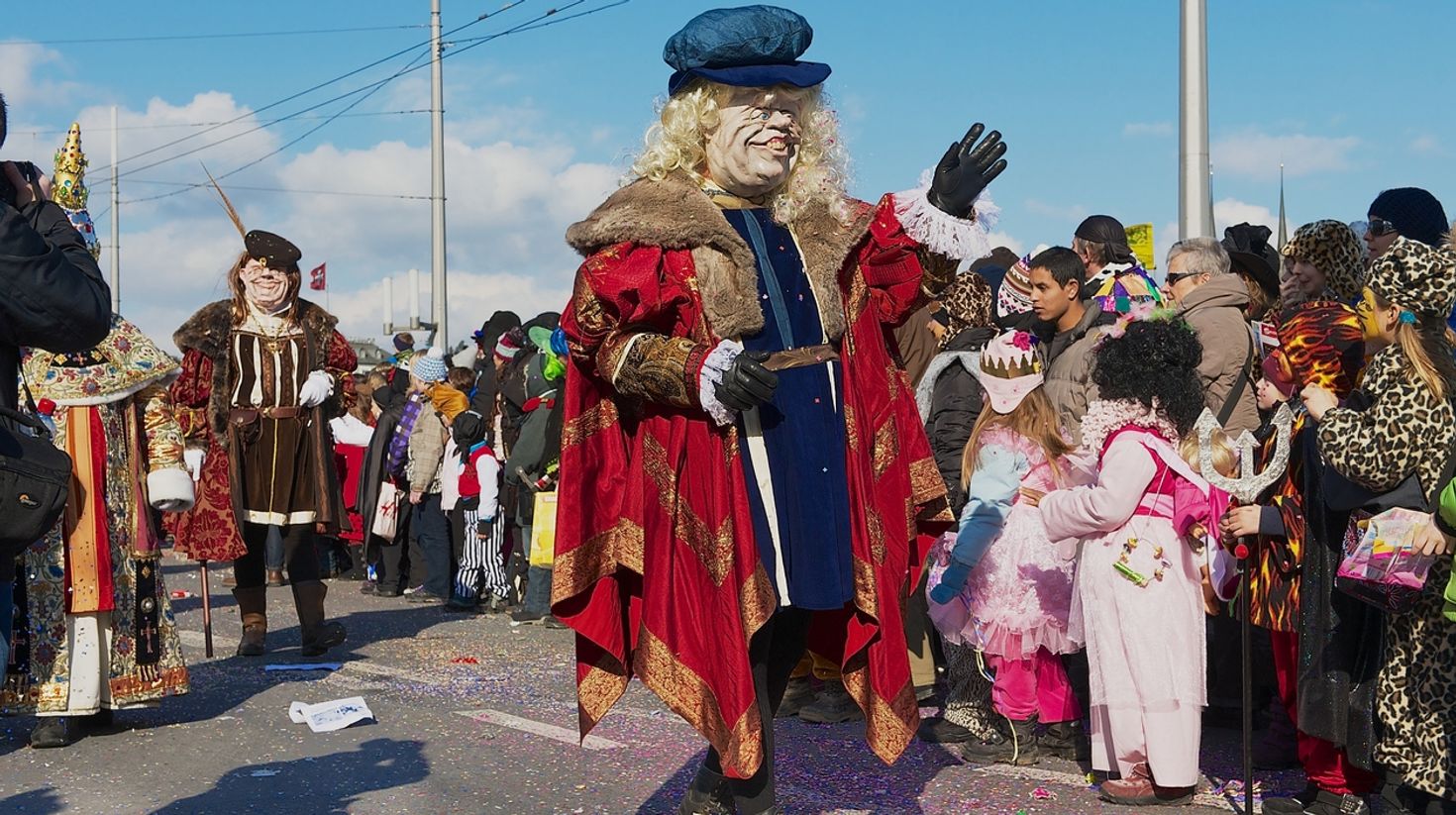 See people in costumes and masks in the Lucerne Carnival.