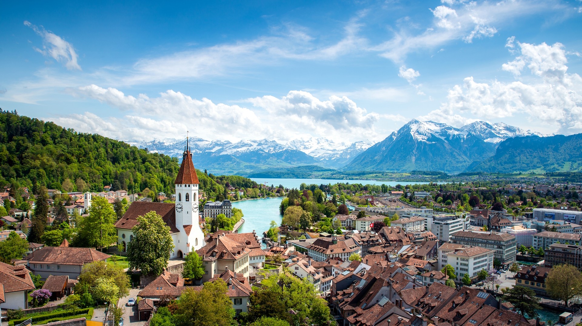 Summer is high season in Switzerland which means you can experience the best the country has to offer. Panoramic view of the city of Thun on a sunny day in Switzerland in summer.