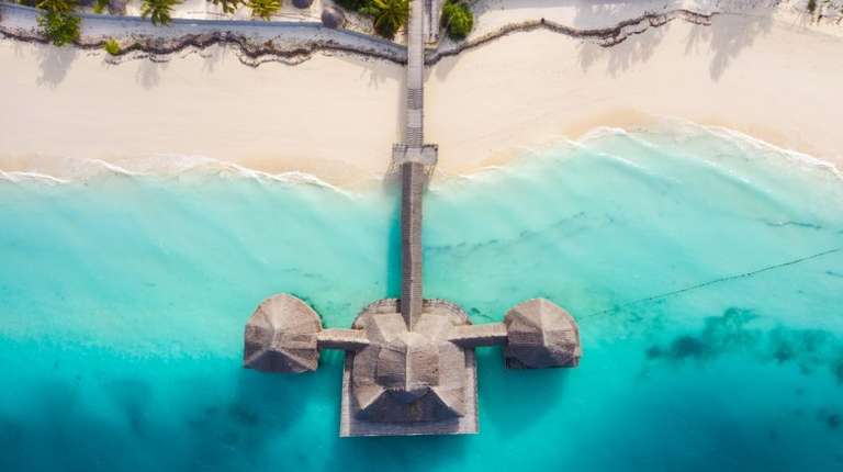 A beach resort built on the shorelines of blue sea water in Tanzania in November.