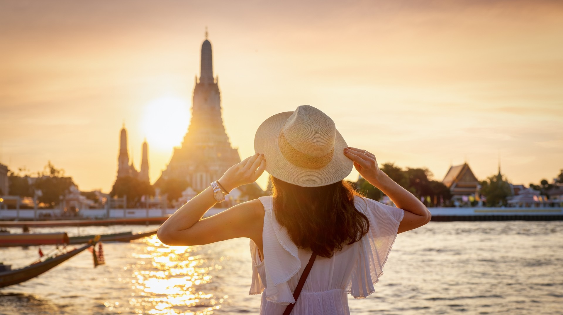 A woman sightseeing the Wat Arun temple during her 5 days in Thailand.