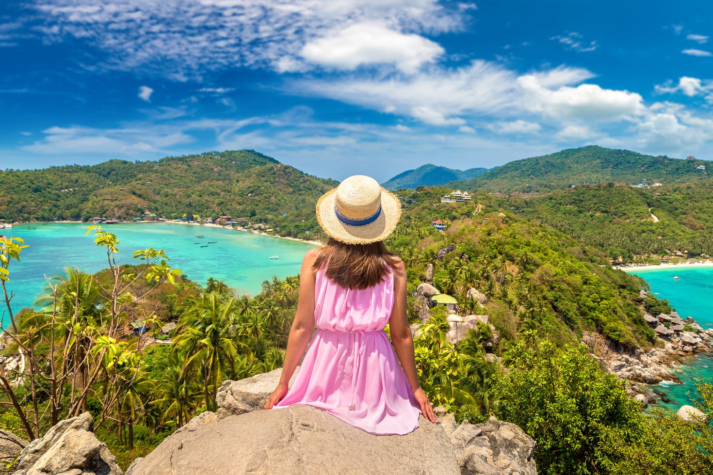 Woman traveler enjoying the view of Ko Tao from the top.