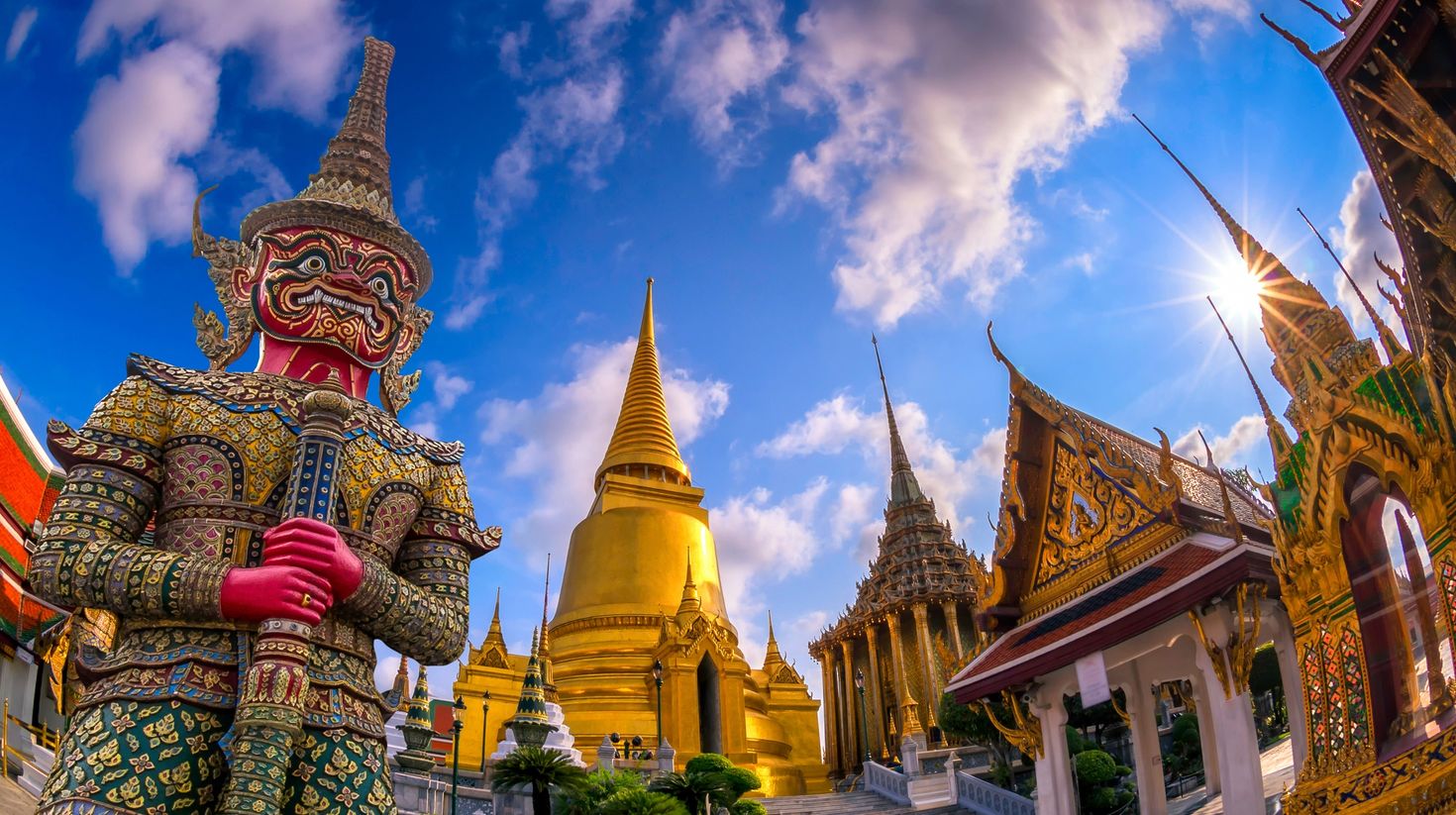 Wat Phraw, the Temple of Emerald Buddha at cloudy blue sky during July.