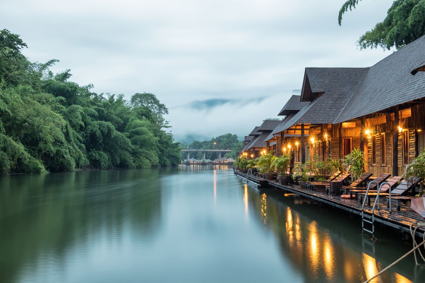 Resort wooden house floating and mountain fog on river Kwai, Thailand