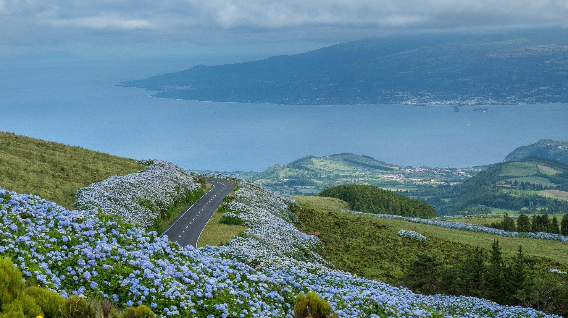 Blue hydrangeas flock the fences in Flores, while the lakes of Sete Cidades see more clear and sunny days in the Azores in April.