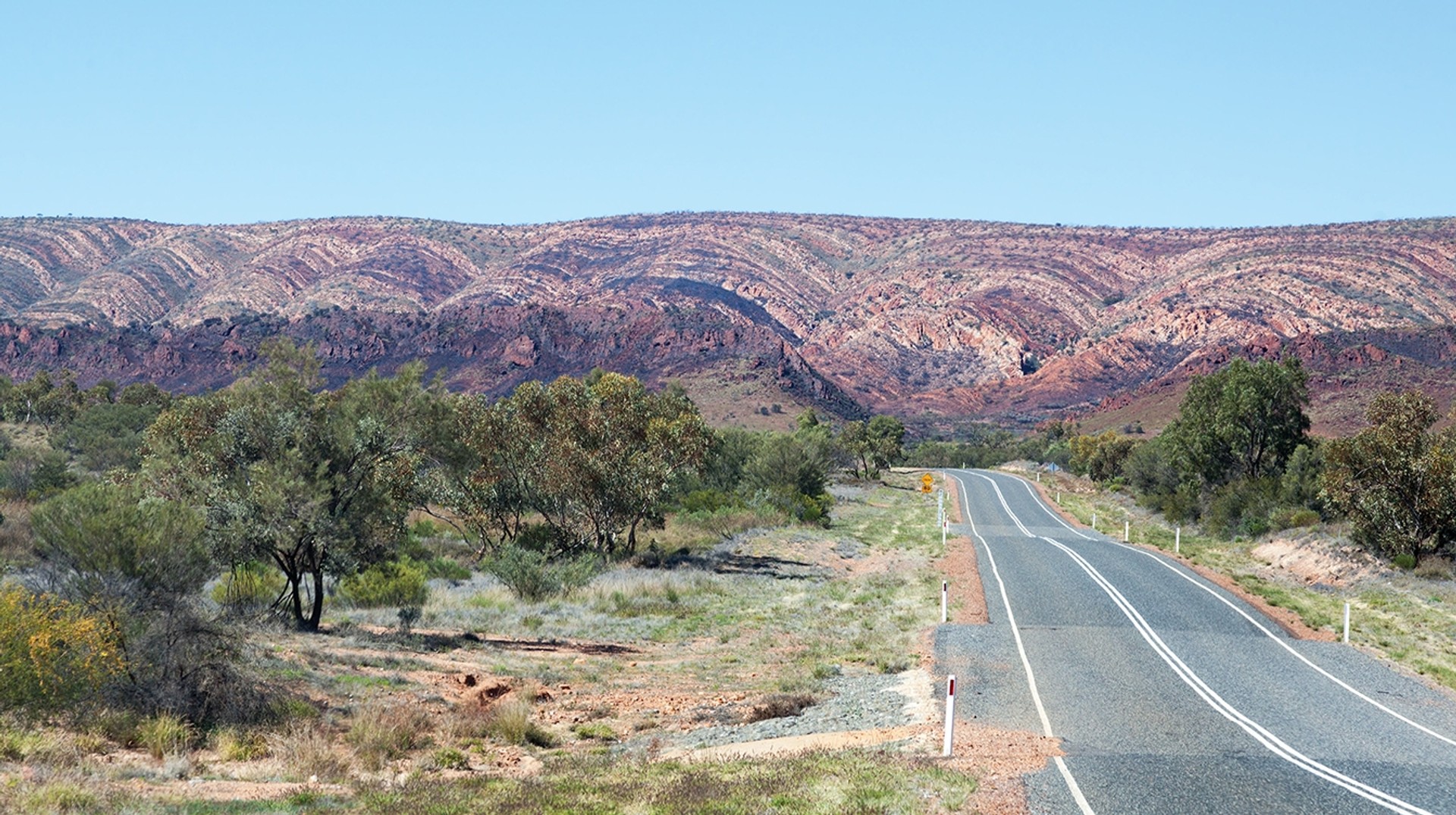 Road leading to West Macdonnell Ranges. The West Macdonnell Ranges in Alice Springs is a great way to spend time in Australia.