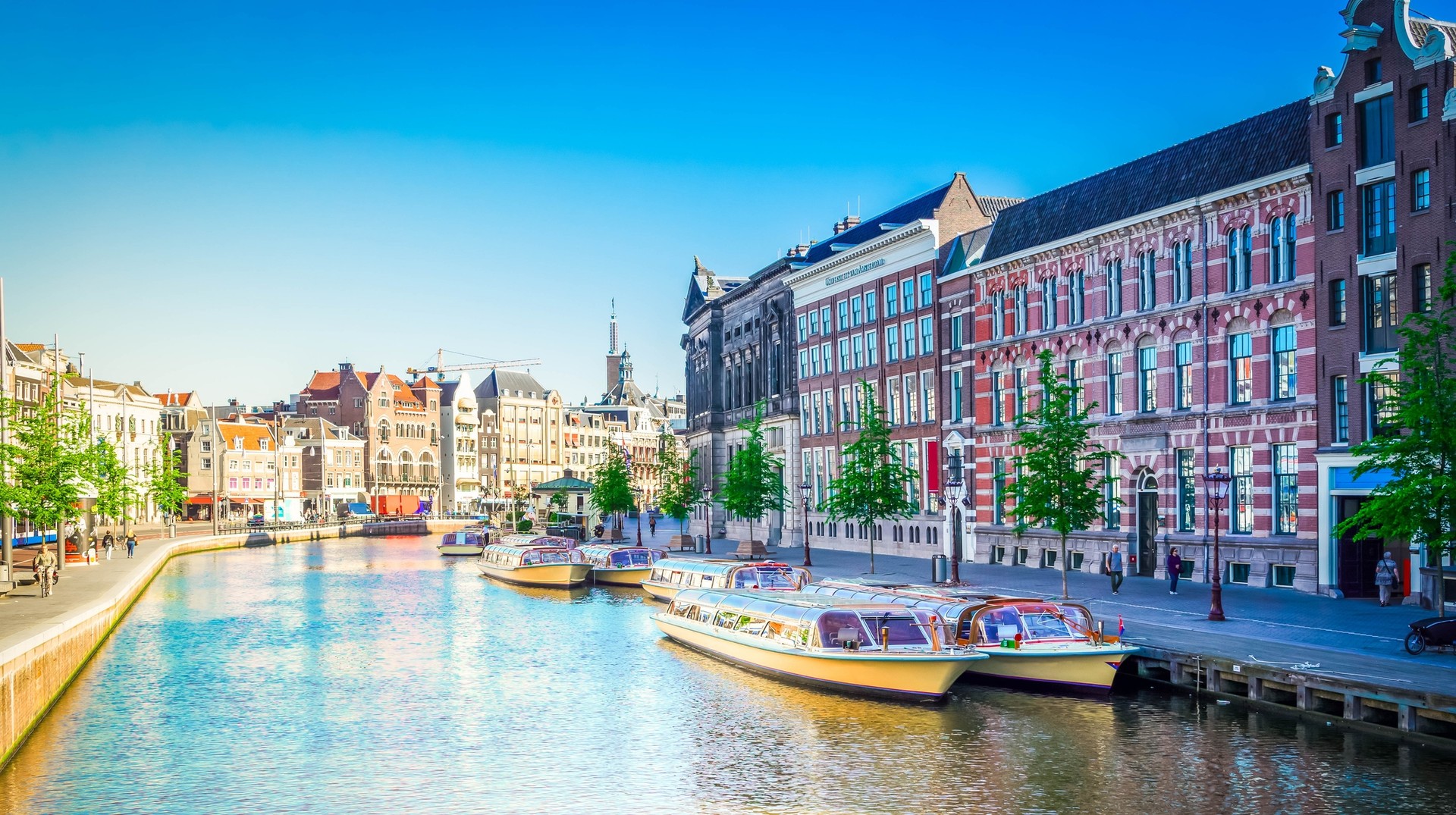Amsterdam canals with boats on a bright summer's day in the Netherlands in July.