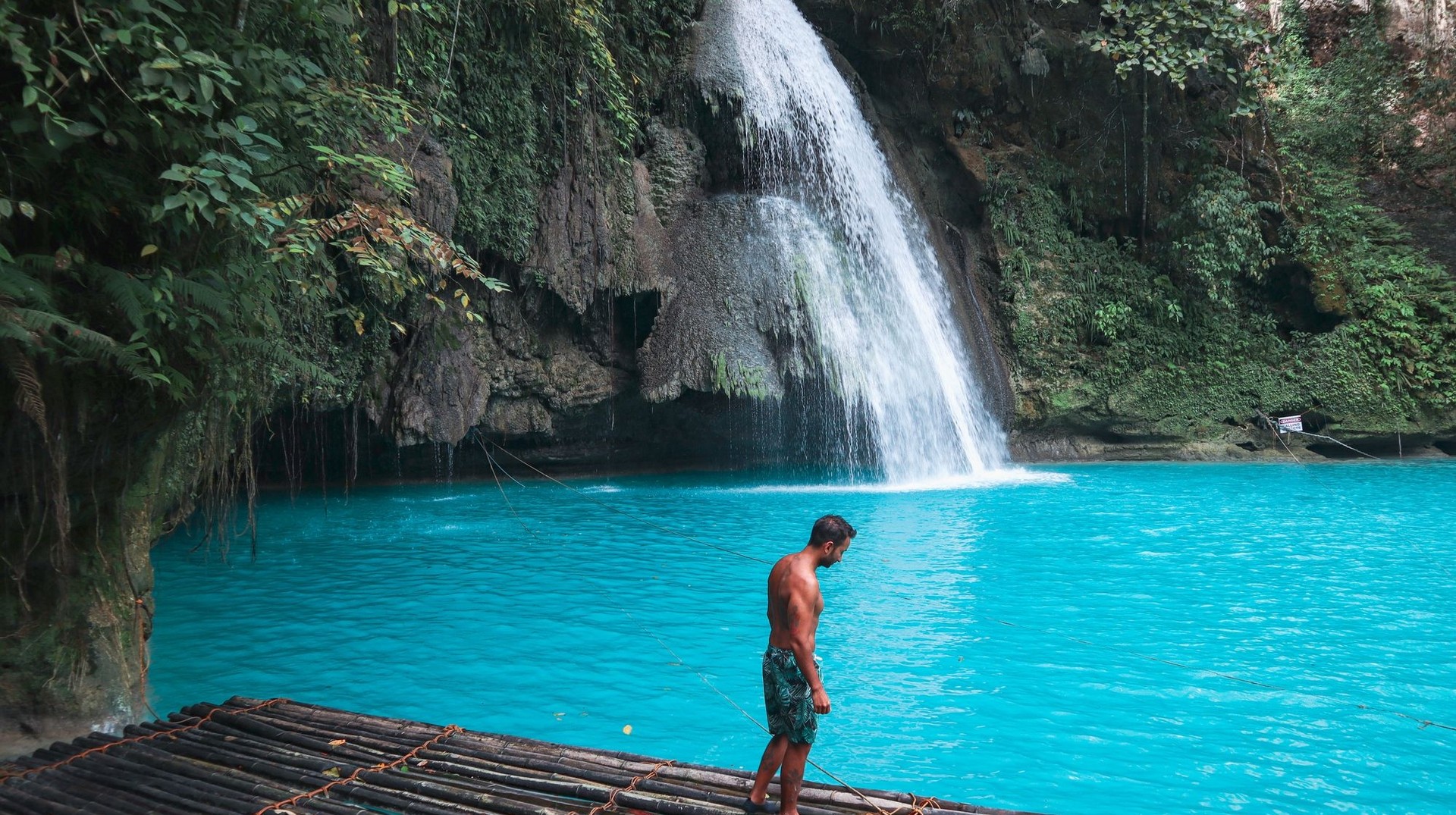 A young man in the wooden raft in Kawasan Falls on Cebu Island during his one week in the Philippines.