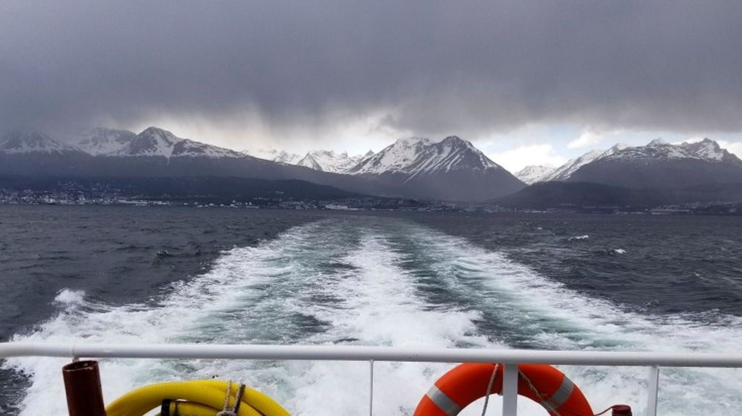 Cruise with mountains in front on a cloudy day in Beagle Channel.
