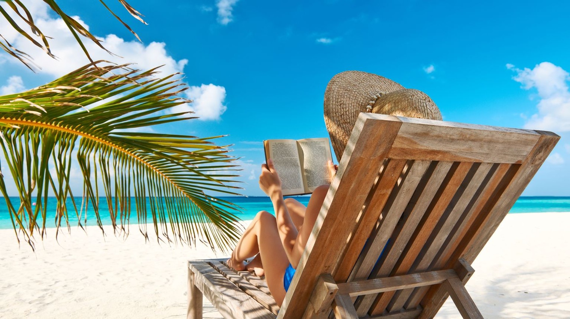 Bask in the sun's radiant embrace on breathtaking beaches, where golden sands meet azure waters - one of the top things to do in Brazil. A girl basking in Copacabana Beach, one of the best things to do in Brazil.