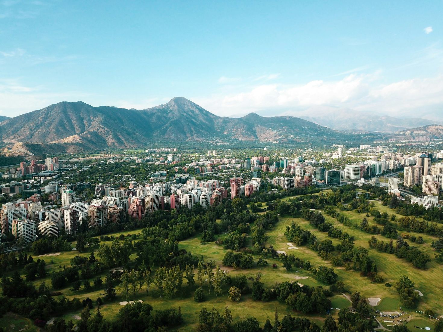 Lush green golf course in Santiago with the view of Andes mountain