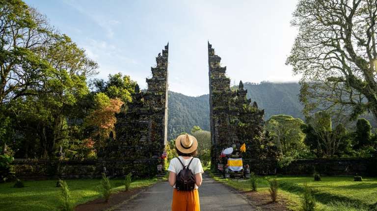 Women tourist travelers explore the Balinese temple, which is one of the top things to do in Indonesia.