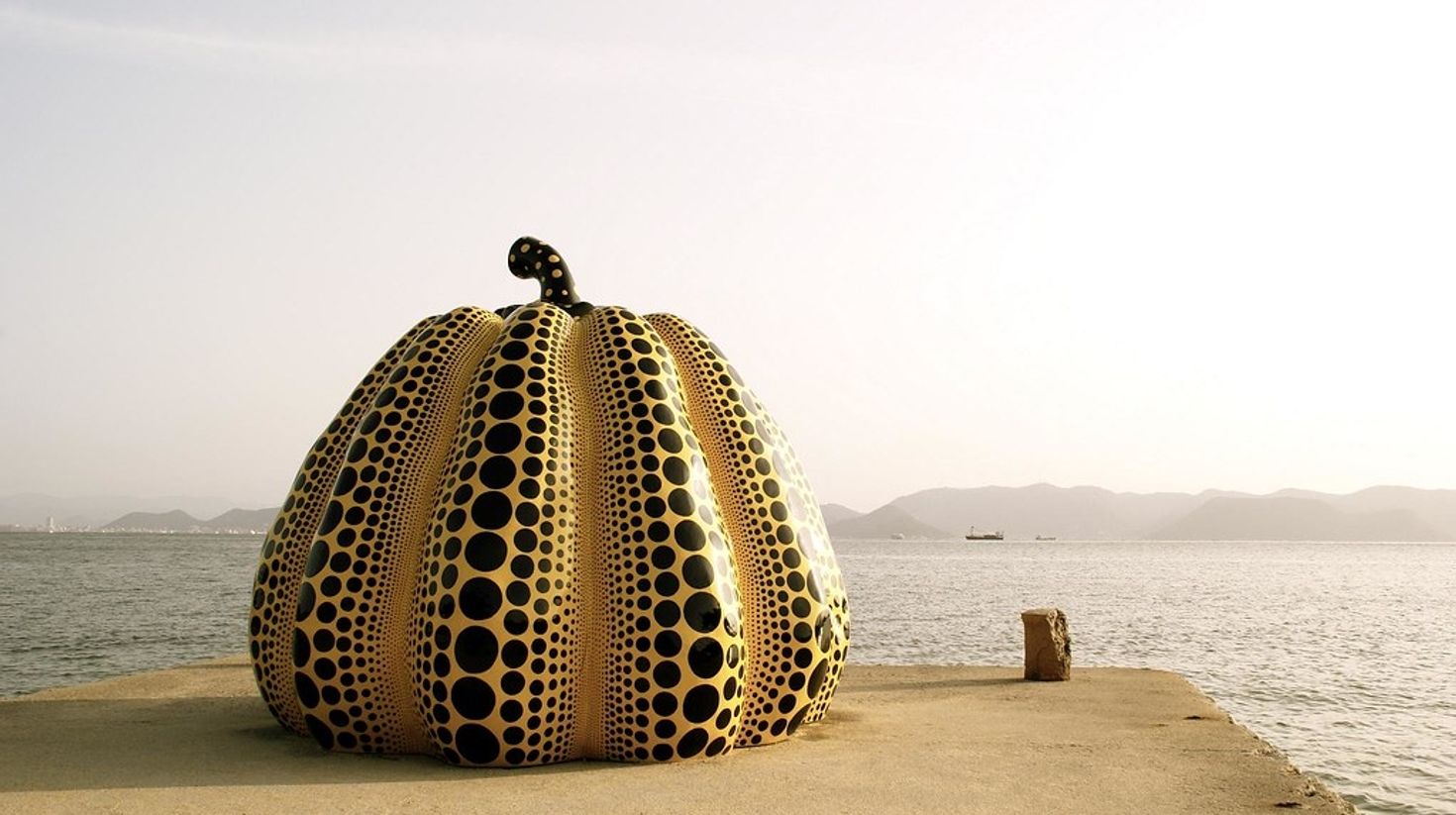 If you're confused about what to do in Japan, check out the iconic yellow pumpkin sits on the Naoshima island.