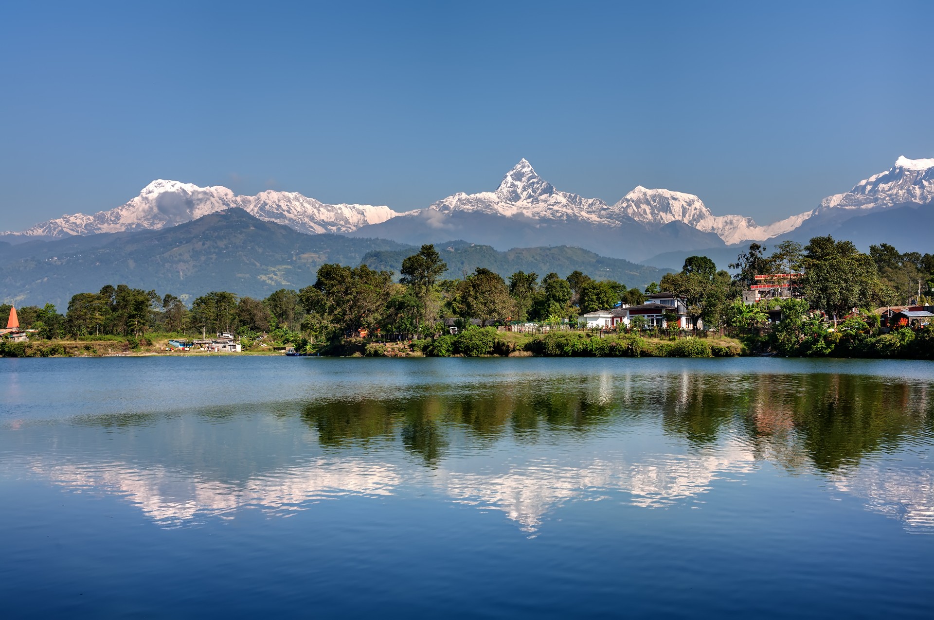 snow-capped mountains, green hills and a lake in Pokhara, Nepal