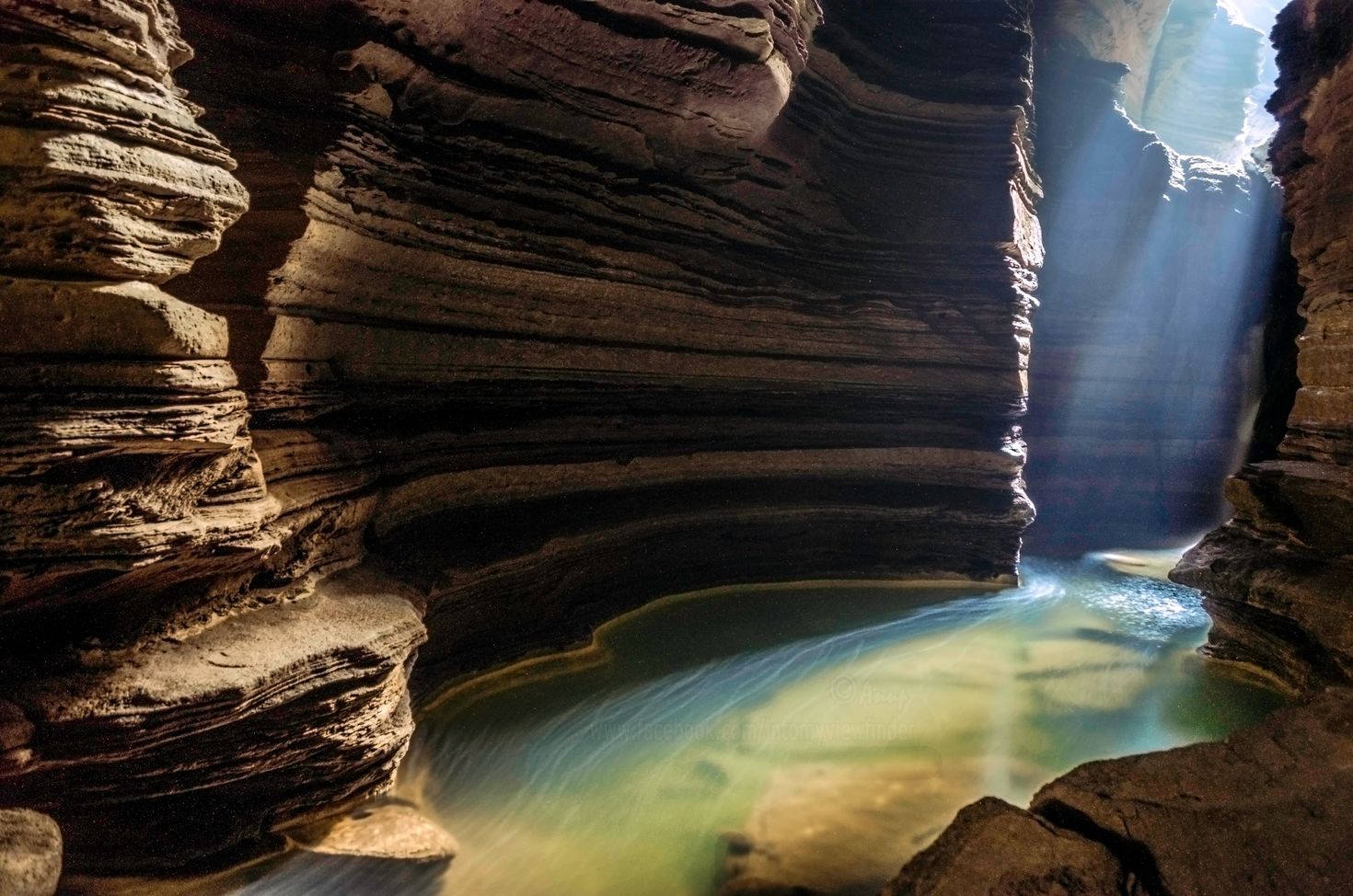 cave with a pool of water inside in Pokhara