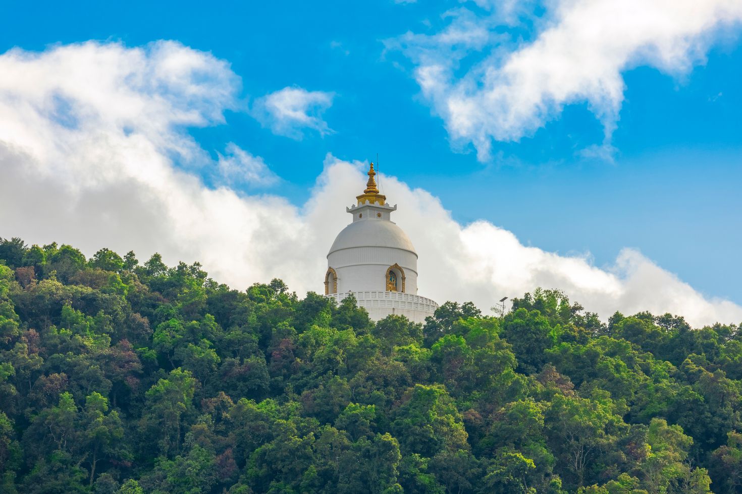White structure on top of the mountain against blue sky