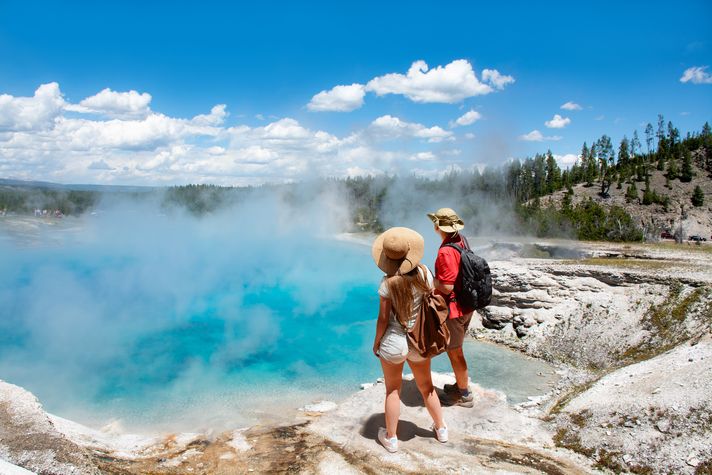 Visitors enjoy the sight of the hot springs in Yellowstone National Park