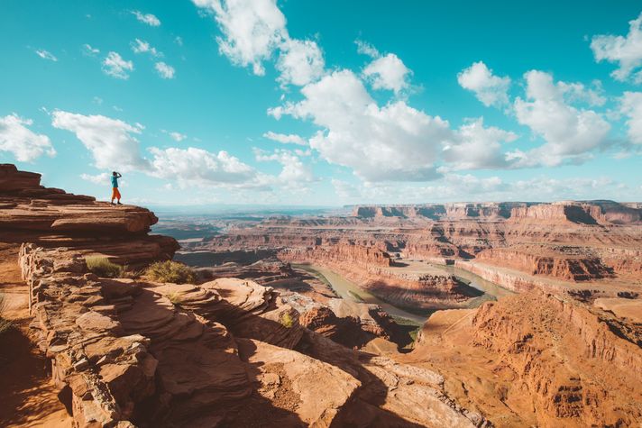 A hiker in the rocky landscape at the Grand Canyon in USA