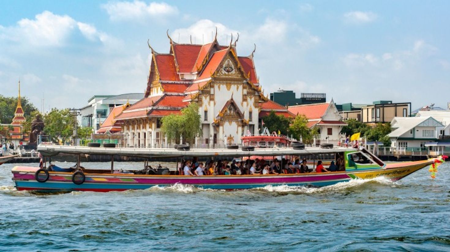 A cruise in Chao Phraya River on a clear day in Bangkok.
