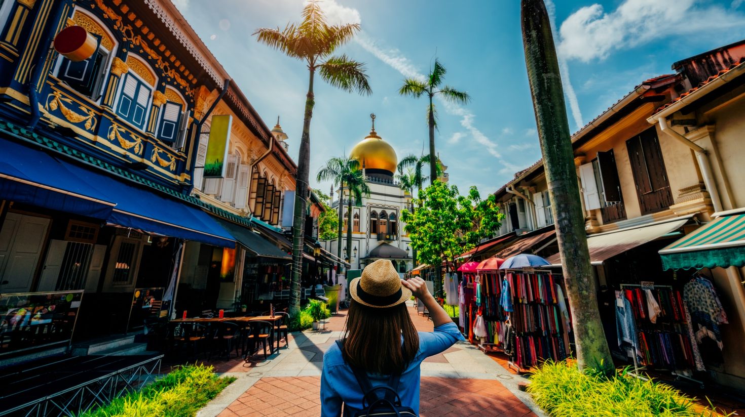 A female tourist with a hat at Kampong Glam.