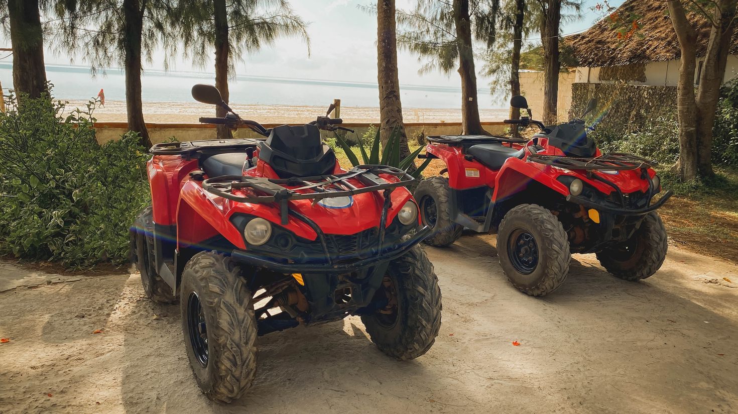 Two quad bikes parked near the beach in Zanzibar.