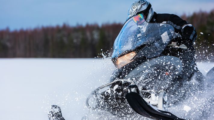 A person riding a snow mobile