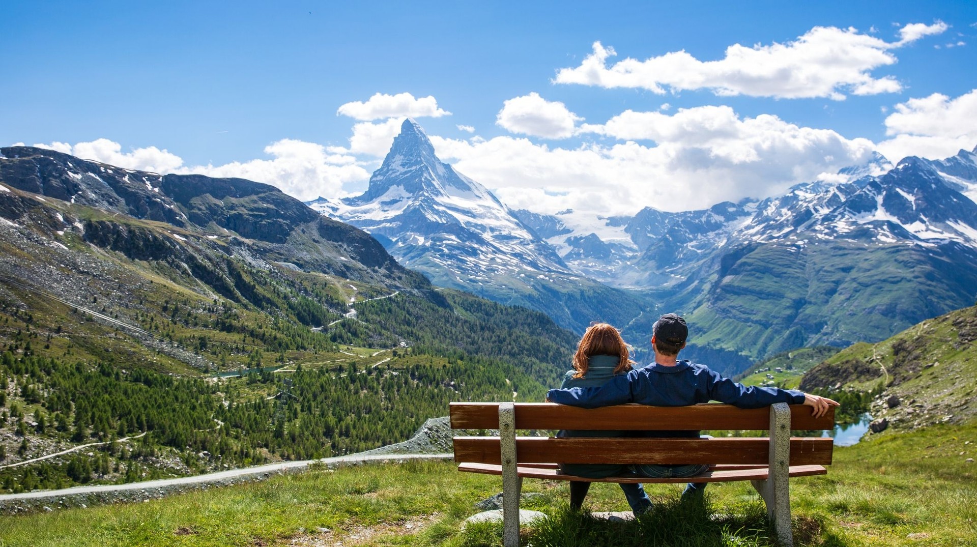 Discover the majestic Matterhorn, one of the top places to visit in Switzerland, offering unforgettable alpine scenery and awe-inspiring views. Couple taking in the view of Matterhorn, one of the top places to visit in Switzerland.