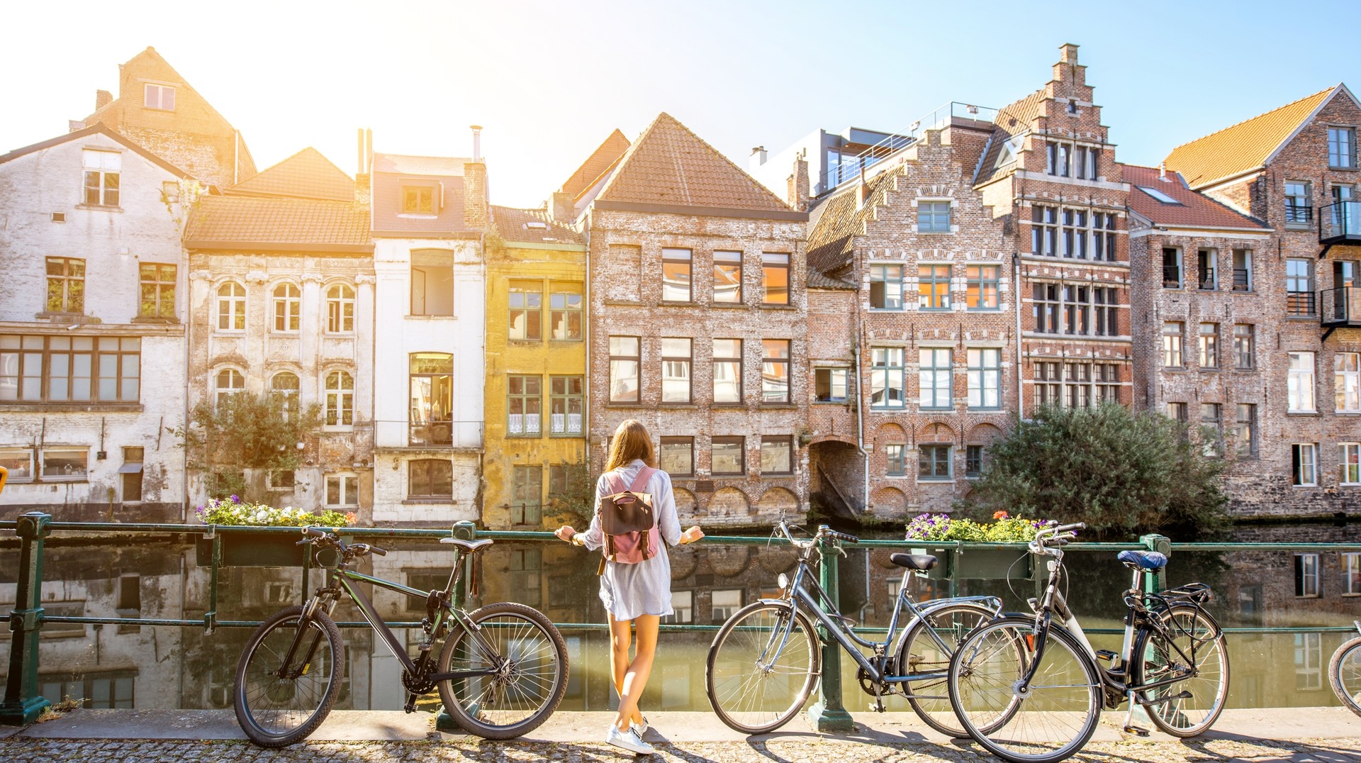 Cycling through the canal of Ghent to explore the city is one of the best things to do in Belgium. Cycling through the canal of Ghent to explore the city is one of the best things to do in Belgium.