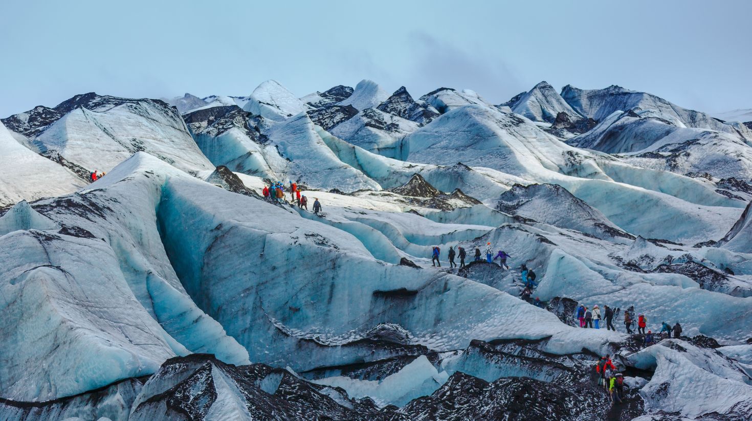 A large group hiking the Solheimajokull glacier.