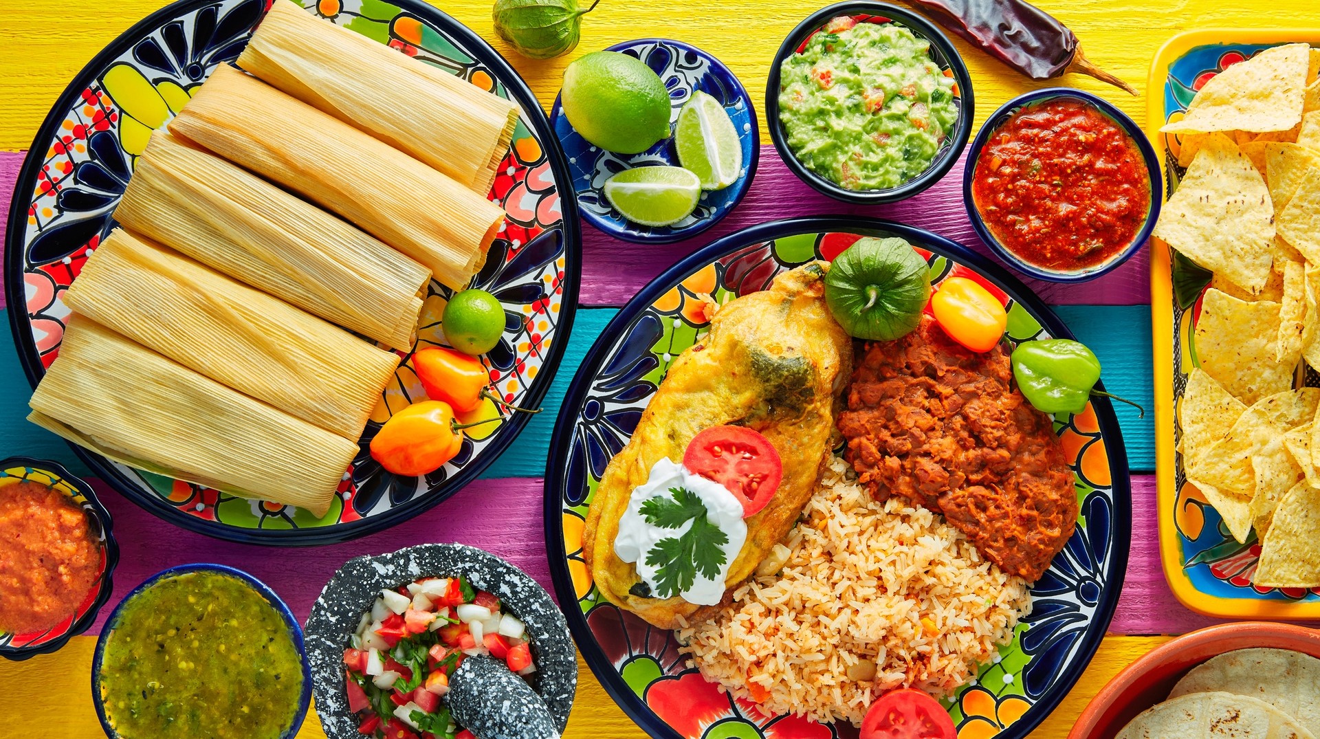 Tantalize your taste buds by introducing them to the exquisite flavors of traditional Mexican food during your adventure in Mexico. A selection of traditional Mexican foods, including tamales and arroz rojo.