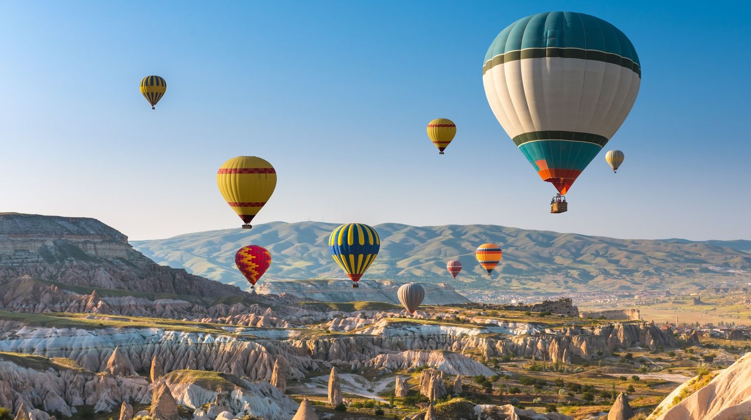 Hot air balloons flying in sunset sky Cappadocia, Turkey.