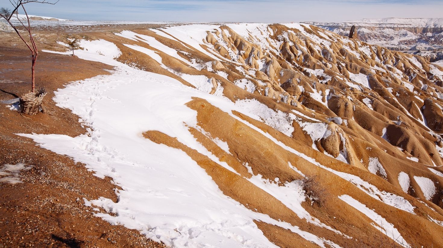 Get this amazing view of snowy Cappadocia while visiting Turkey.
