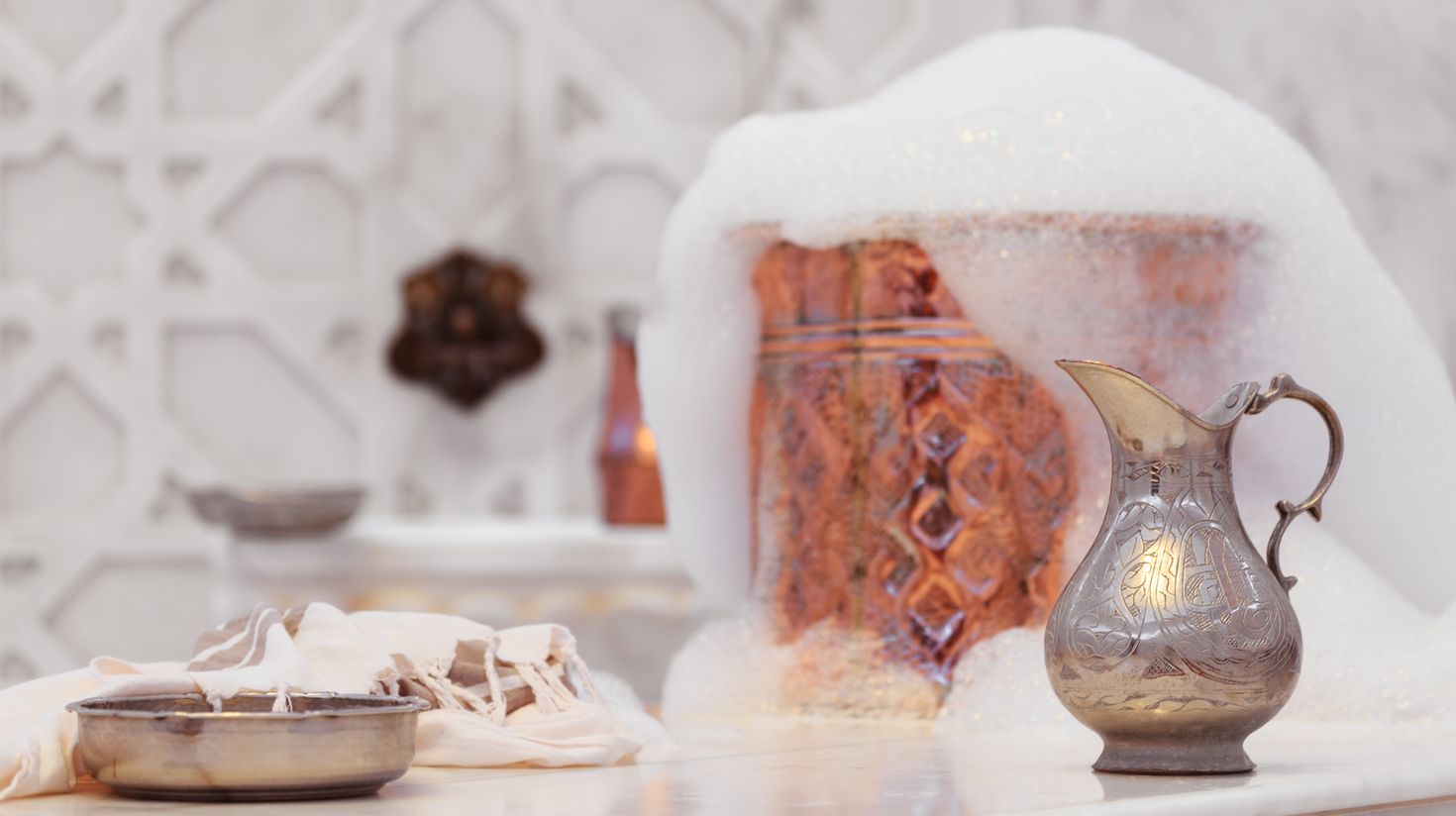 Copper bath bowl with soap foam in a Turkish hammam.