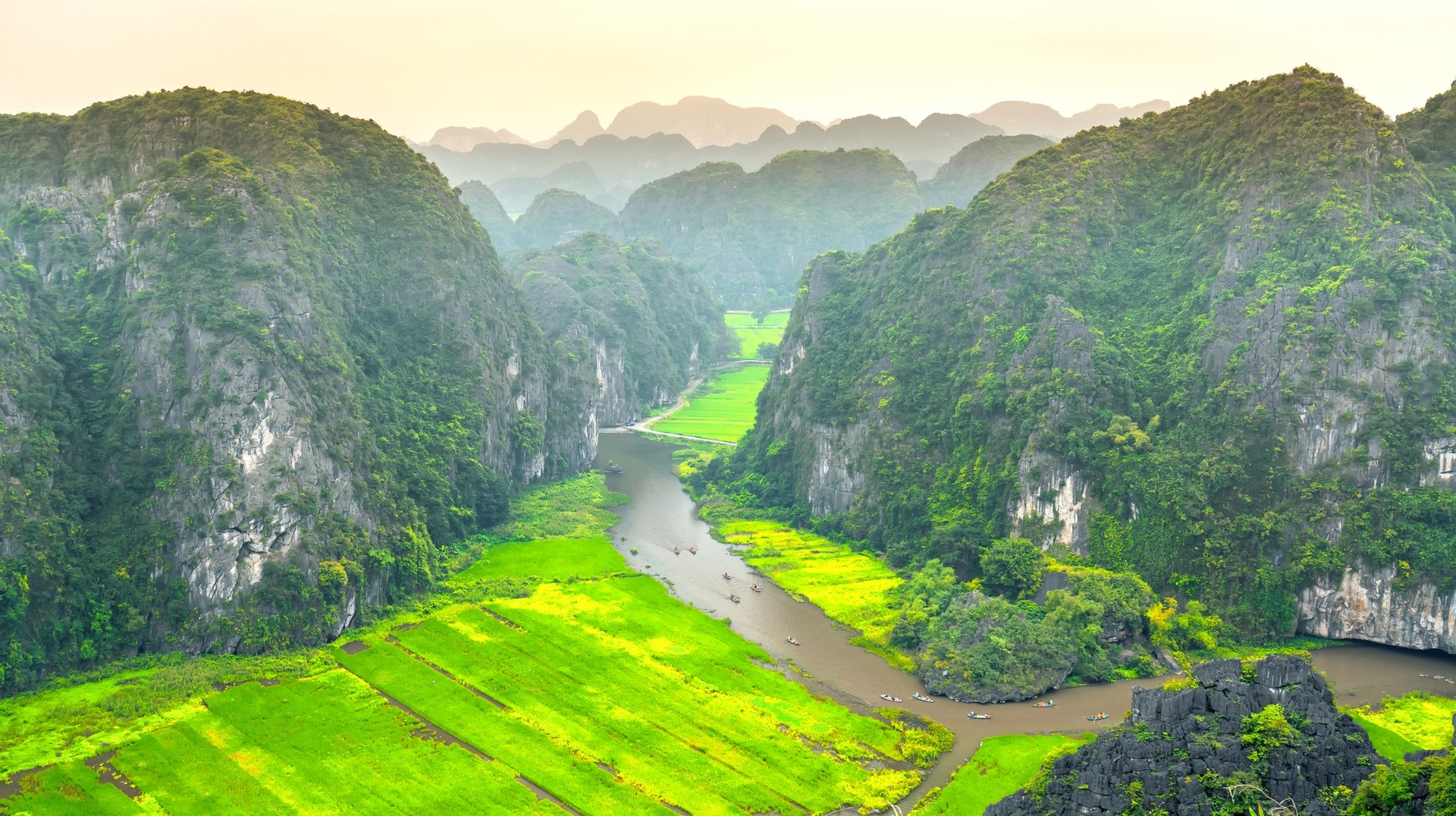 It's a rainy affair in most of Vietnam in June but you can still take advantage of fewer crowds while sightseeing. Stunning view of Tam Coc area while visiting Vietnam in June.