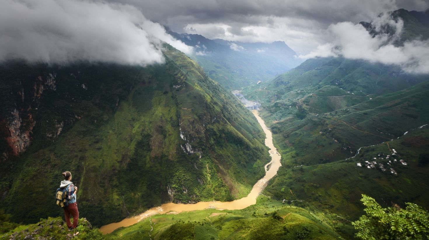 A hiker enjoying the view of the mountains in Ma Pi Leng, Vietnam.