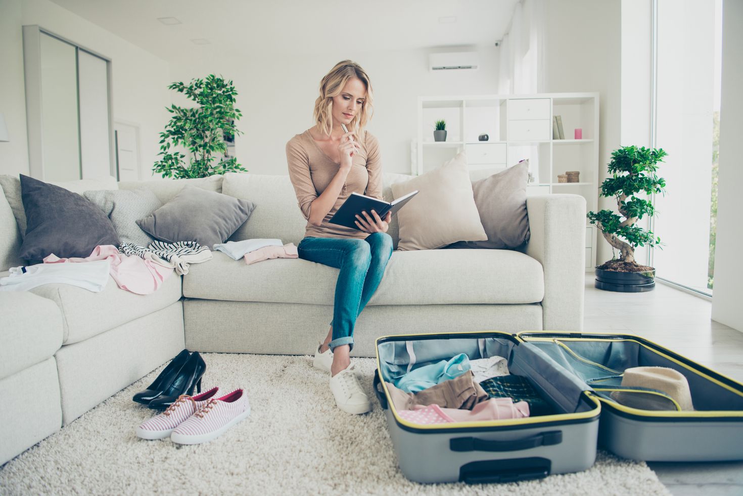 A woman going through her last-minute checklist when packing her things