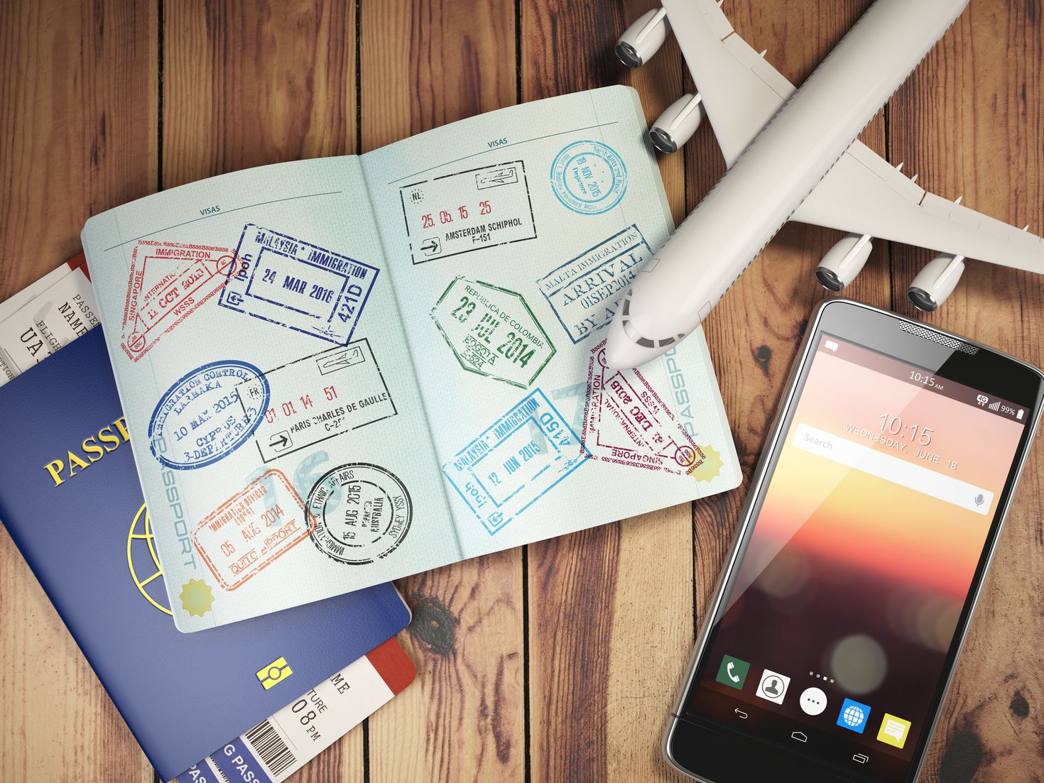 Immigration stamps, a toy airplane and a cellphone signifying travel