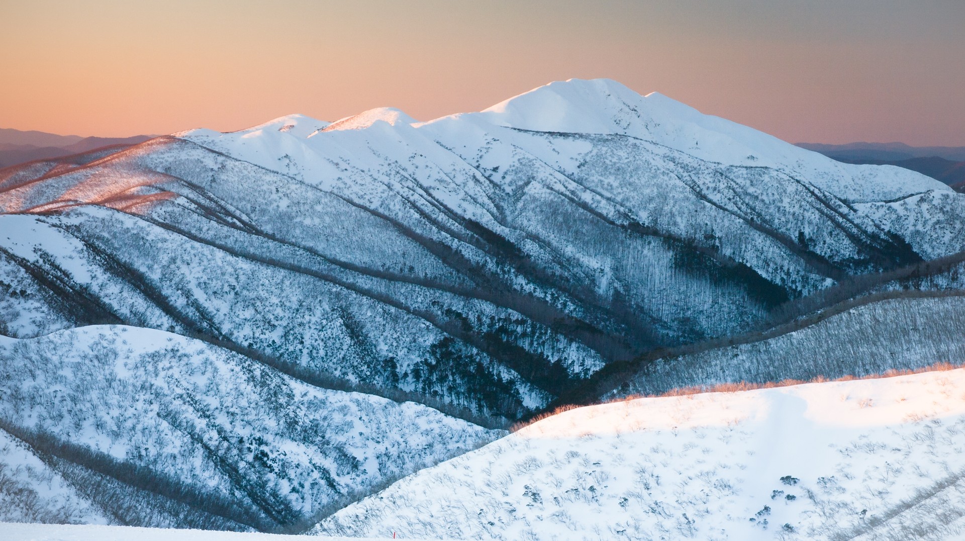 Winter is a great time to enjoy snow sports and festivals in Australia. Mount Feathertop covered in snow at sunset in winter in Australia.