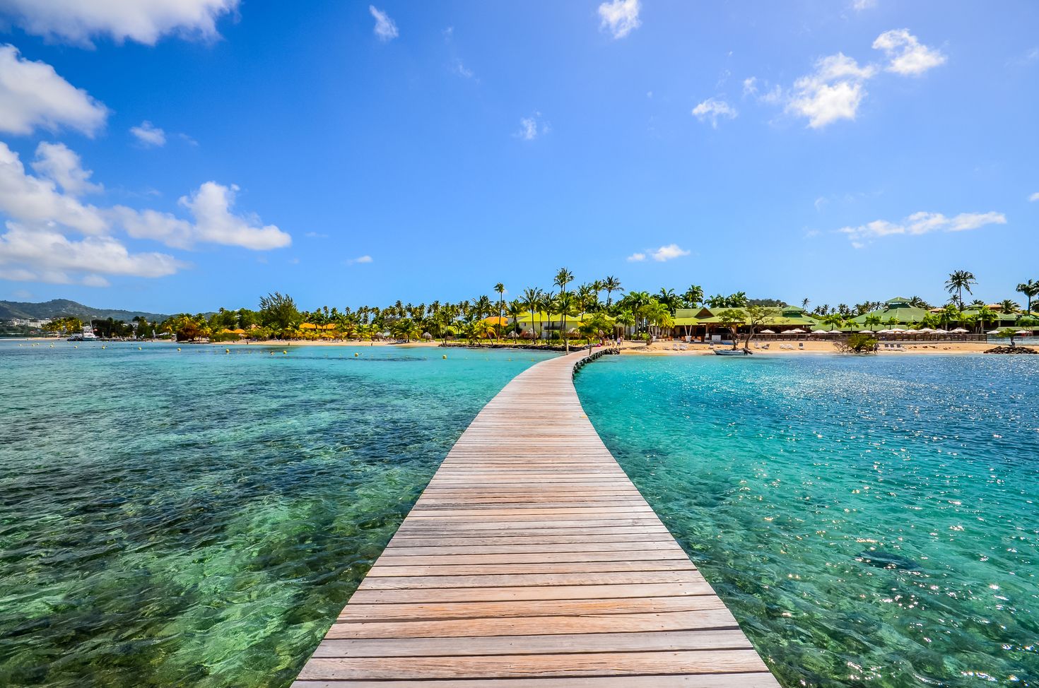 clear water with a pontoon leading to an island in Martinique in France