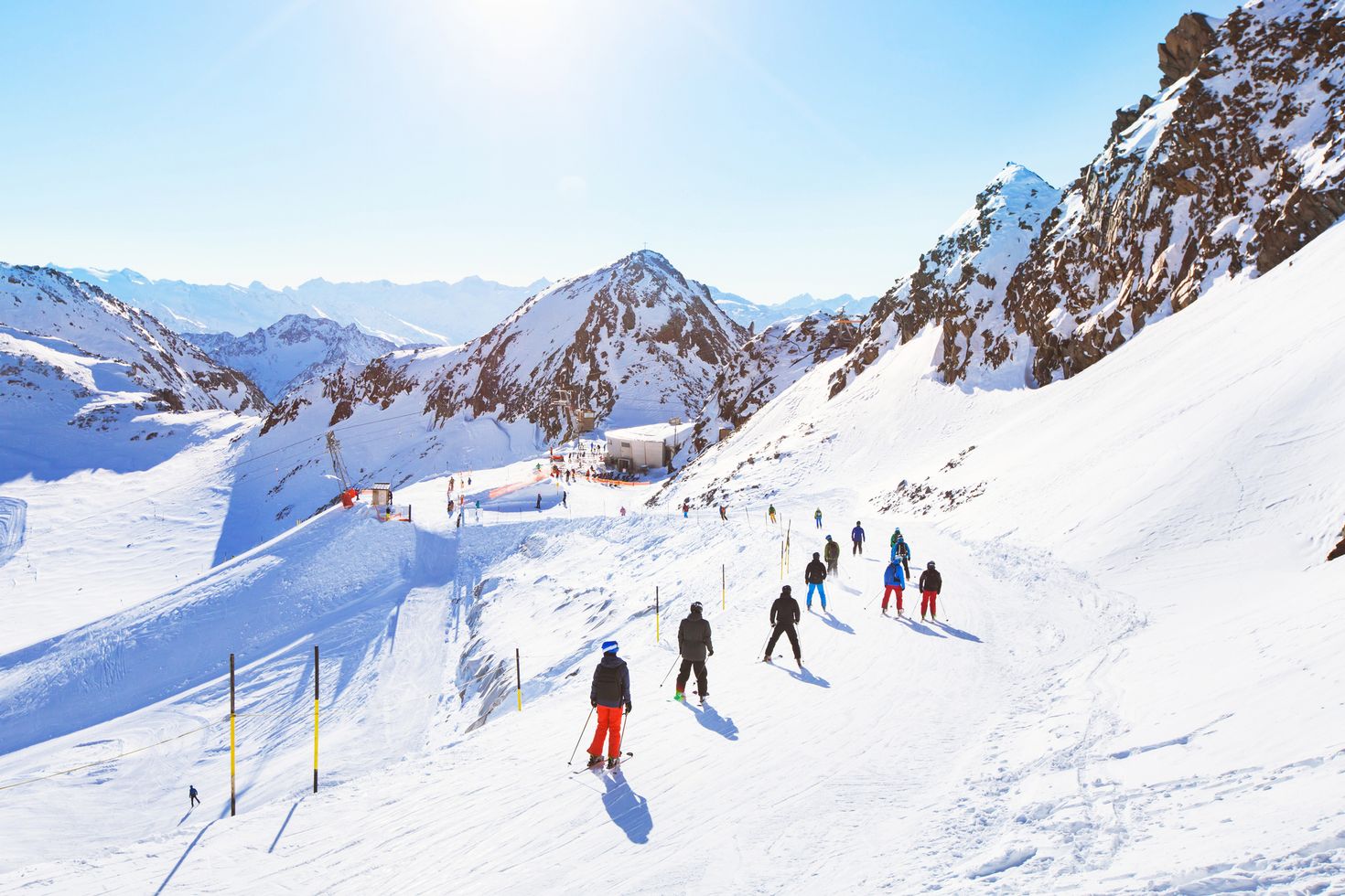 skiers ski down a slope in the France Alps