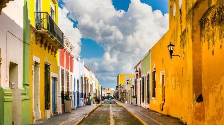 Colorful houses line up on stone paved streets during winter in Mexico.
