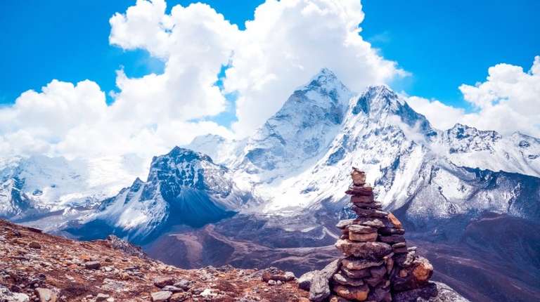 A pile of rocks with mountains in the background in winter in Nepal.