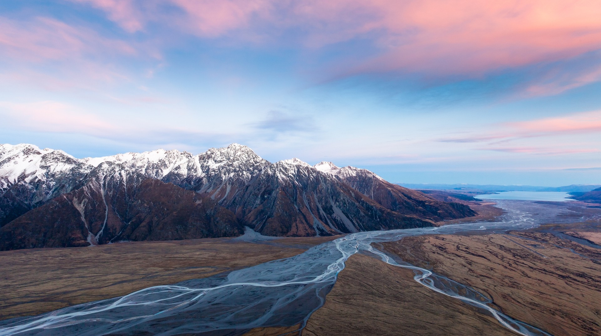 Aoraki Mount Cook National Park in winter in New Zealand with red clouds.