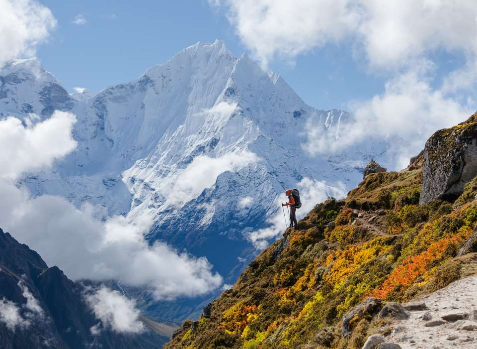 Hiker walks on train in Himalayas
